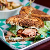 Grilled Salmon BLT Sandwich · Atlantic salmon with Applewood bacon, lettuce, tomato, and cucumber dill aioli. Served on ma...