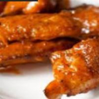 Buffalo Wings · Cooked wing of a chicken coated in sauce or seasoning. Served with celery and blue cheese or...