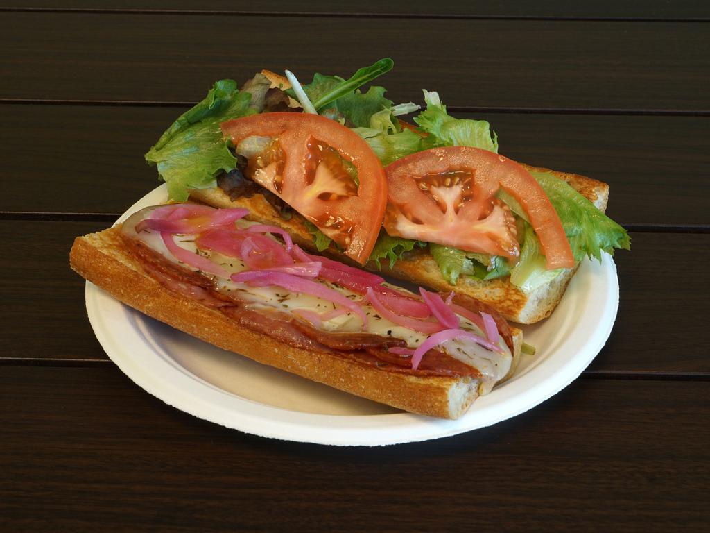 Italian Sub · Salami and pepperoni under provolone with red onions, tomatoes and organic greens on a French baguette.