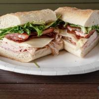 Club Sub · Roasted turkey and ham with bacon, provolone, tomatoes, organic greens and house
made honey ...