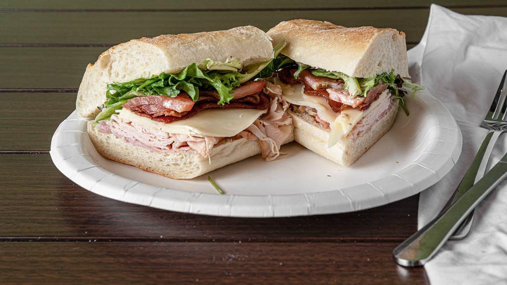 Club Sub · Roasted turkey and ham with bacon, provolone, tomatoes, organic greens and house
made honey mustard on a French baguette.