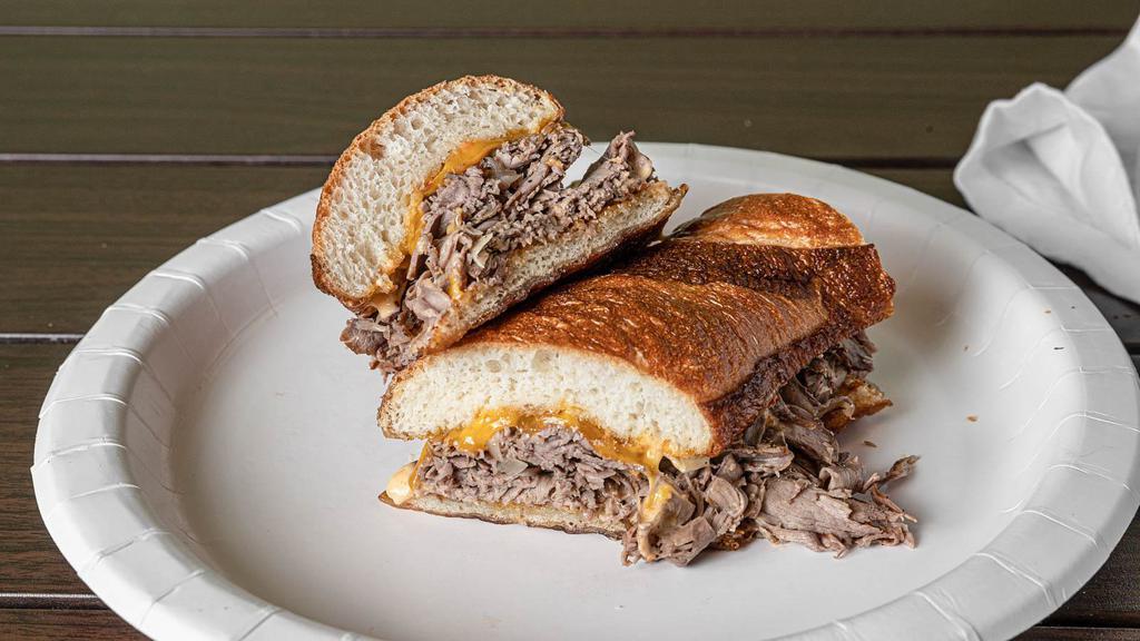 Cheddar Roast Beef Sub · Roast beef under cheddar cheese with grilled onions and cherry pepper aioli on wheat baguette or choice bread.