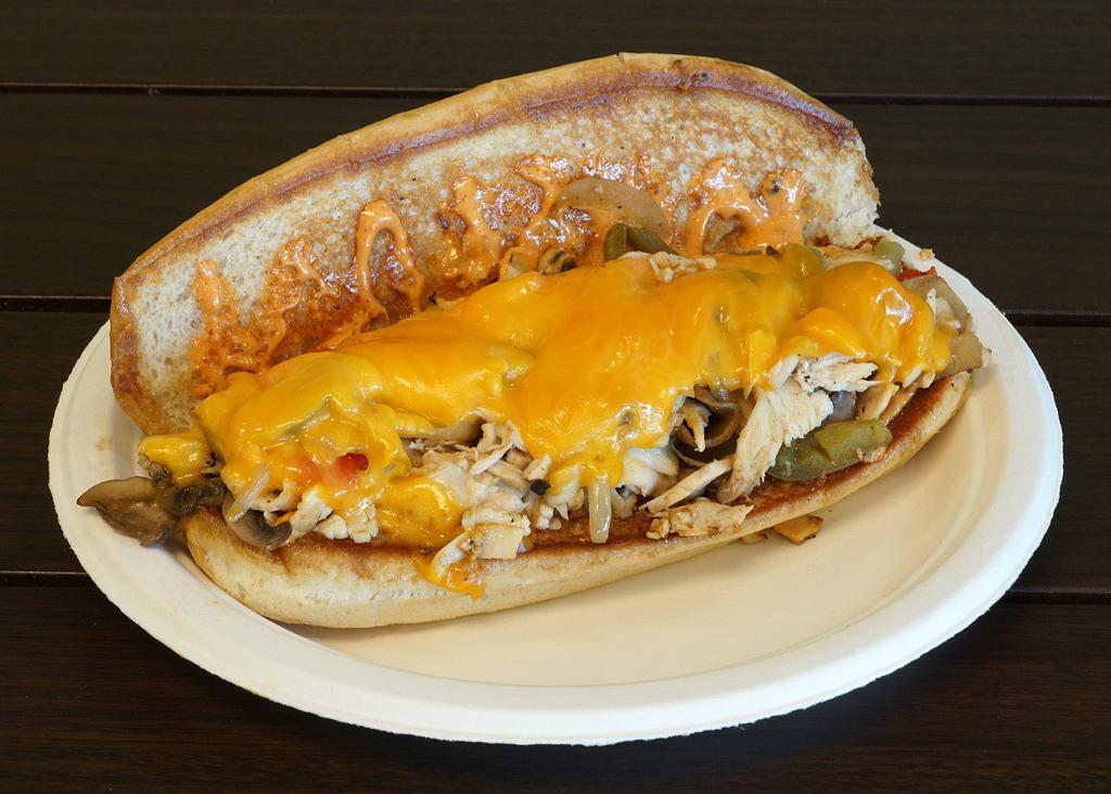 Chicken Philly Sub Combo · Chicken under cheddar with grilled red peppers, green peppers, grilled onions, grilled mushrooms and chipotle mayo on a hoagie roll. Includes choice of side and drink