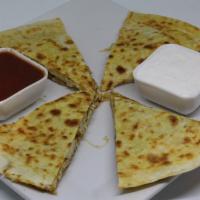Quesadillas · Filled with cheese and grilled onions, served with sides of salsa and sour cream.