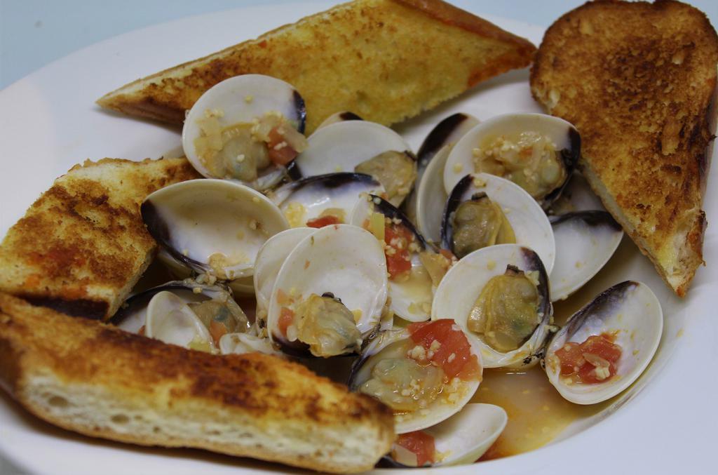 Clams in White Wine Garlic Sauce · 1 lb. of clams cooked in white wine garlic sauce, side salad and garlic bread.