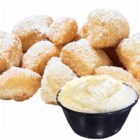 Glazed Fried Yummy Dough · Our original Fried Dough + topped with powdered sugar + served with a side of VANILLA Frosti...