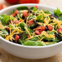 Garden Salad · Crisp seasonal greens topped with fresh diced tomatoes, shredded Wisconsin cheddar cheese an...
