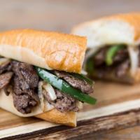 Philly Cheese Steak · Thinly sliced sirloin steak, grilled to perfection, mixed with caramelized onions and topped...