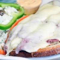 Reuben Sandwich · Grilled corned beef and tangy sauerkraut on rye bread topped with melted Swiss cheese and se...