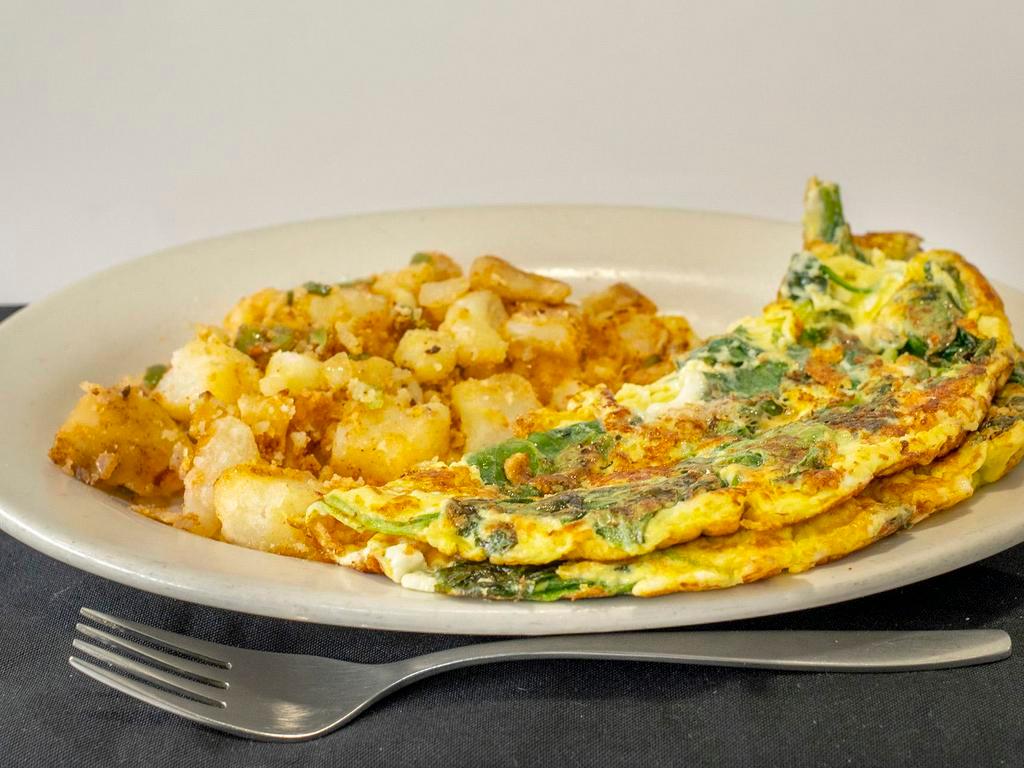 Spinach and Feta Omelette · Three farm fresh egg omelet with spinach and feta cheese. Choice of Home Fries, Crinkle Cut Fries, *Sweet Potato Fries or *Tomatoes. Choice of Bread (*For an additional charge)