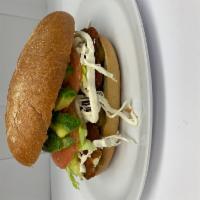 Milanesa De Pollo Mexican Sandwich · Breaded chicken. Served with refried beans, oaxaca cheese, lettuce, tomatoes, onion, chipotl...