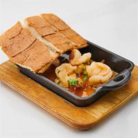 Camarones Al Ajillo · shrimps sautéed in a butter wine garlic sauce served with toast.