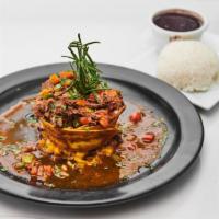 Ropa Vieja · Braised shredded beef in a plantain basket over fufu, demi glace, served with rice and beans.
