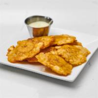 Tostones · green plantains flattened served with a garlic sauce
