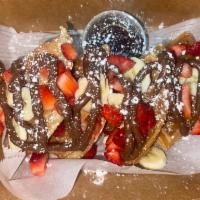 Strawberry Kiss Waffle · Classic waffle with powdered sugar. Drizzled in Nutella, strawberry, and banana.