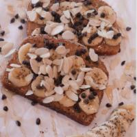 Peanut Butter Toast · Peanut butter spread topped with fresh banana and drizzled with honey 