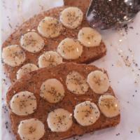 Almond Butter Toast · Almond Butter spread topped with fresh banana and chia seeds, drizzled with honey