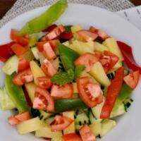Cucumber Salad · Vegan. Fresh cucumbers with bell peppers, shredded carrots, pineapple tidbits, and red tomat...