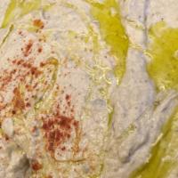 Hummus · Mashed grabazo beans mixed with tahini, garlic and lemon juice. Served with pita.