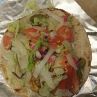 Chicken Wrap · Grilled chopped chicken rolled into a pita taco style with out house salad and choice of sau...
