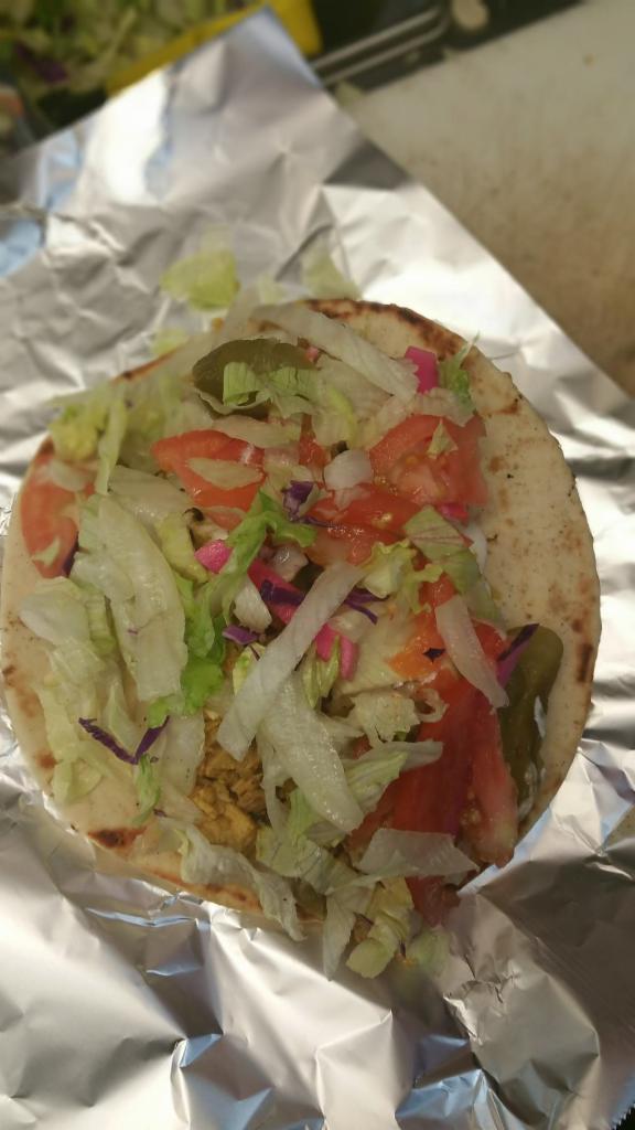 Chicken Wrap · Grilled chopped chicken rolled into a pita taco style with out house salad and choice of sauce.
