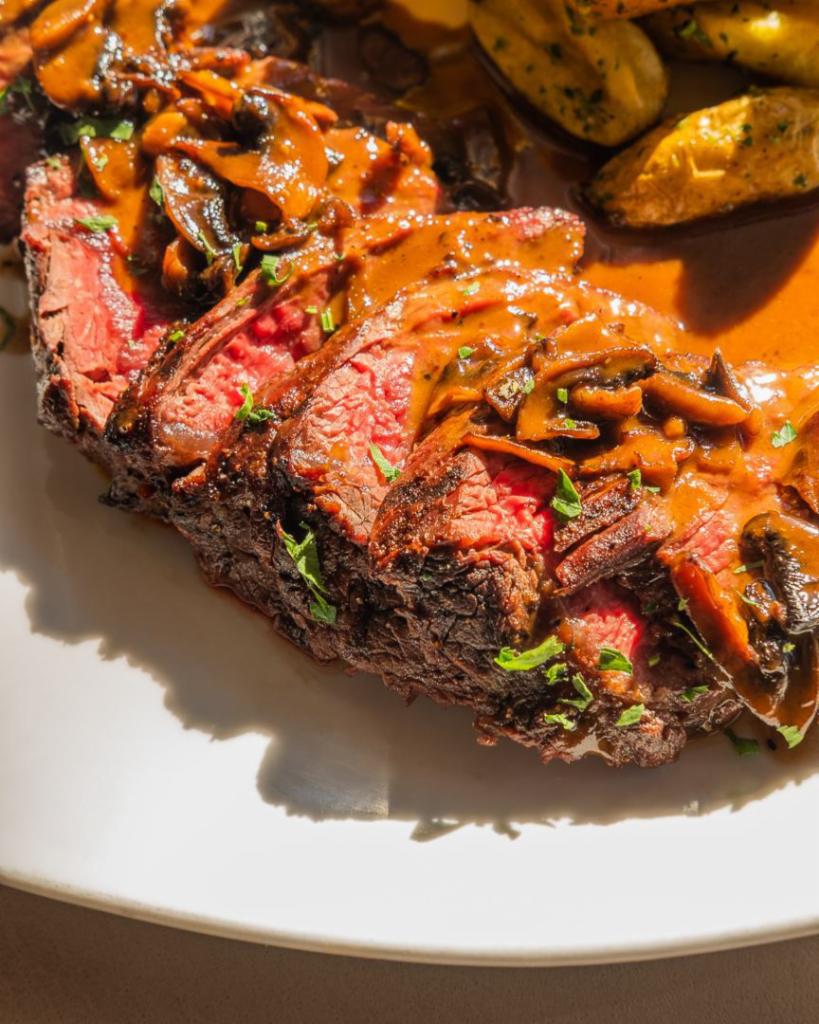 Hanger Steak · grilled steak with roasted fingerling potatoes tossed with gremolata brandy mushroom sauce.