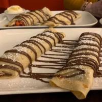 Nutella Crepe · Crepe filled with Nutella and topped with powdered sugar.