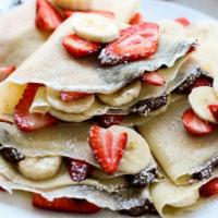Nutella Royale Crepe · Crepe filled with Nutella, bananas, strawberries and topped with powdered sugar.