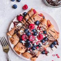 Nutella Berry Crepe · Crepe filled with Nutella, strawberries and blueberries, topped with powdered sugar.