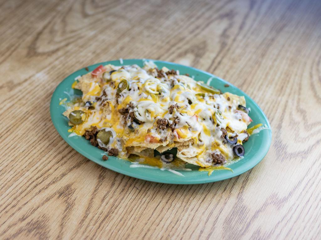 Macho Nacho Supreme with Salsa · Corn tortilla chips with choice of beef or chicken, cheddar cheese, onion, black olives, tomatoes, jalapenos, sour cream.