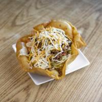 Taco Salad · Fresh greens in a freshly fried tortilla bowl topped with seasoned ground beef or chicken, c...