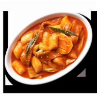 Spicy Rice Cake (떡볶이) · Ddokbokki. Rice cakes, fish cake, cabbage, and sesame in hot sauce. Extras egg, ramen, chees...