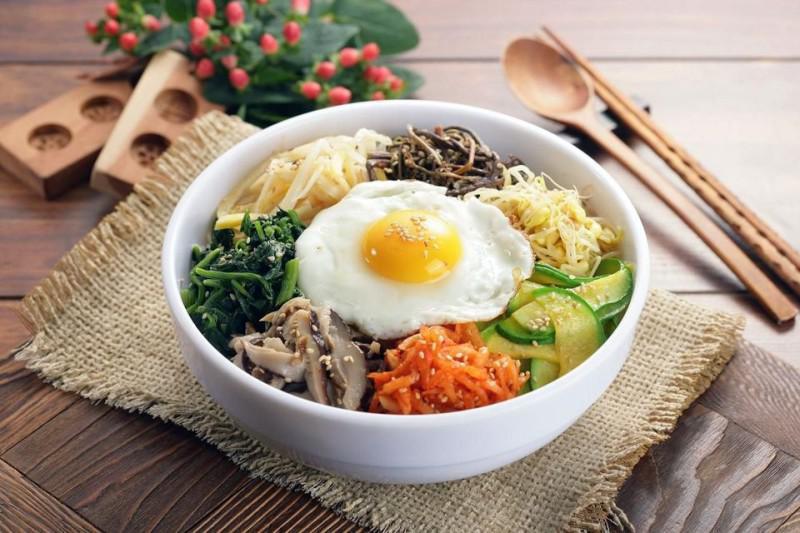Bibimbap (비빔밥) · White rice, medley of vegetables topped with a fried egg and miso soup. 