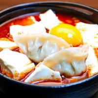 Dumpling Soft Tofu Soup (만두순두부) · Soft tofu stew with Dumpling, vegetables, soft tofu and egg in spicy broth. Served with rice. 