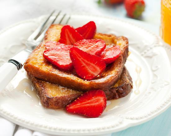 Strawberry French Toast · Sliced challah bread soaked in eggs and milk, then fried and topped with strawberries.