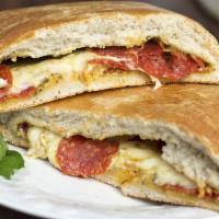 Steak Special Calzone · Mozzarella cheese, steak, pepperoni, mushrooms, green peppers, fried onions.