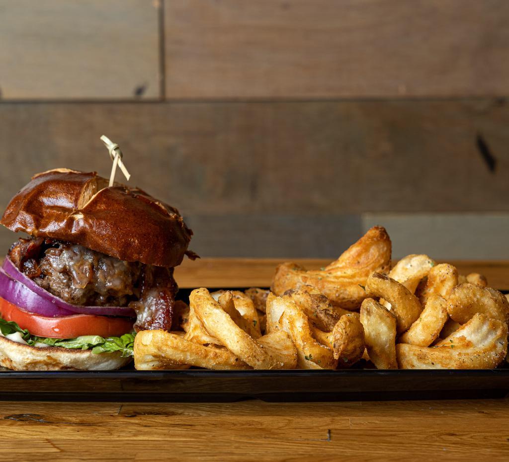 Bourbon Burger · Juicy burger patty glazed in our homemade whiskey sauce served on a pretzel bun with mayo and crisp romaine lettuce all under smoked gouda cheese.
