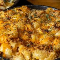 Jack N' Mac · Traditional blend of sharp and white cheddar cheeses melted over macaroni and glazed with ou...