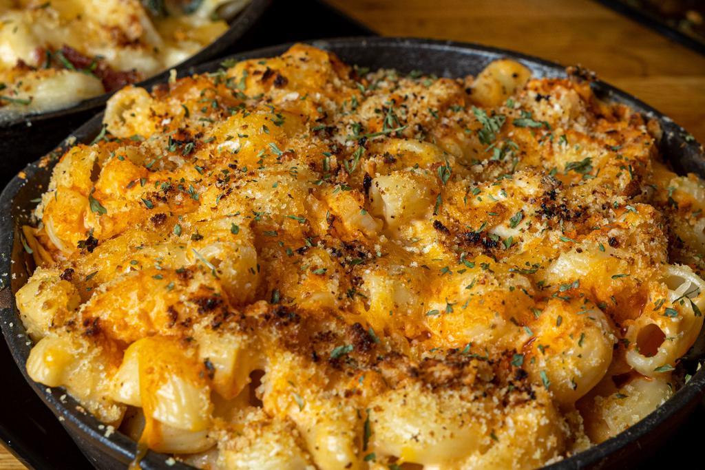 Jack N' Mac · Traditional blend of sharp and white cheddar cheeses melted over macaroni and glazed with our whiskey glaze.
