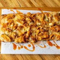Buffalo Chicken Flatbread ·  Spicy buffalo chicken strips served baked under a blend of mozzarella and provolone cheeses...