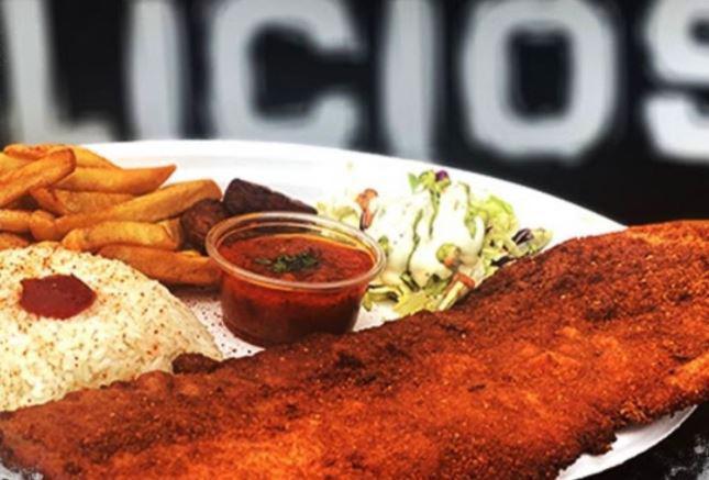 Signature Dish “El Chuletazo” · Large breaded pork tenderloin cutlet served with rice, fries, sweet plantains, house salad, lime and hogao sauce.