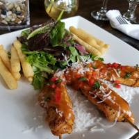 Grilled Chicken Satay · Served with organic baby greens, yucca fries and peanut butter-coconut sauce.