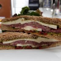 Prosciutto and Fresh Mozzarella Sandwich · Served with sun-dried, basil and balsamic vinegar on whole wheat bread. Comes with a complem...