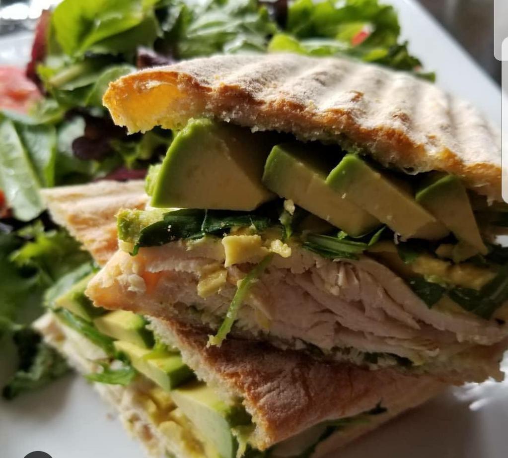 Grilled Chicken and Avocado Panini · Served with baby arugula and basil pesto on ciabatta bread. Comes with a complementary salad.