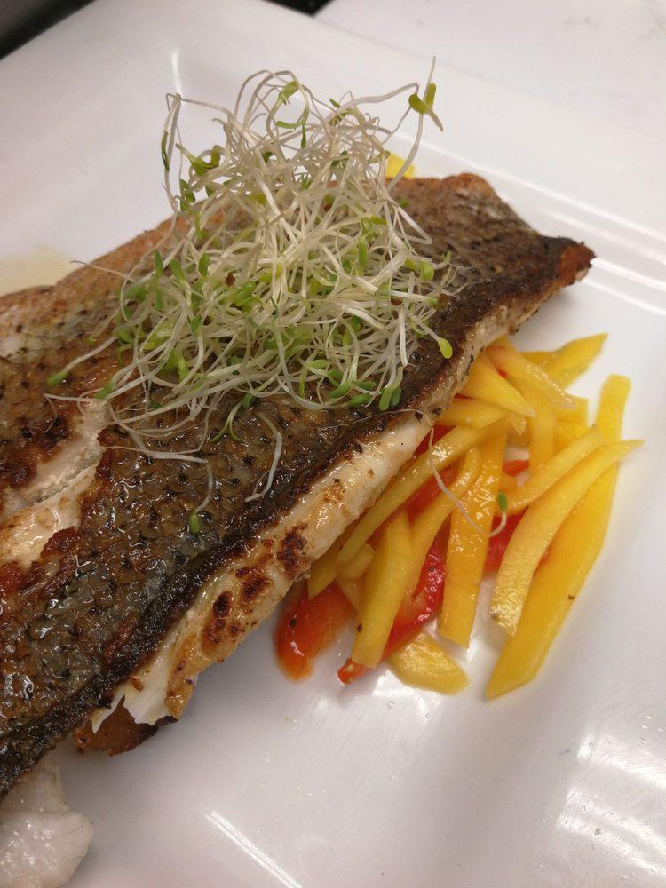 Pan Seared Striped Bass · Served with citrus mango salad and baked sweet plantains.