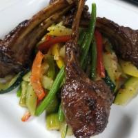 Australian Baby Lamb Chop · Served with homemade mashed potatoes, mixed vegetables and a roasted lamb and Cabernet Sauvi...