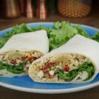 The Leonidas Wrap · Green Chili Hummus, feta, tomato and black olive spread, onions, spinach and brown rice in a...