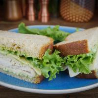 Turkey and Basil Pesto Sandwich · Roasted Turkey, Provolone, Basil Aioli and green leaf lettuce on wheat bread. (Nut free)