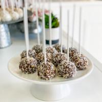 Almond Joy Cake Pop · An almond coconut cake dunked in milk chocolate and covered in crushed almonds and toasted c...