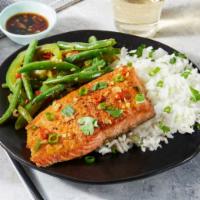 salmon fish over rice🍲 · salmon fish over rice which salad lettuce ,and tomato and onions